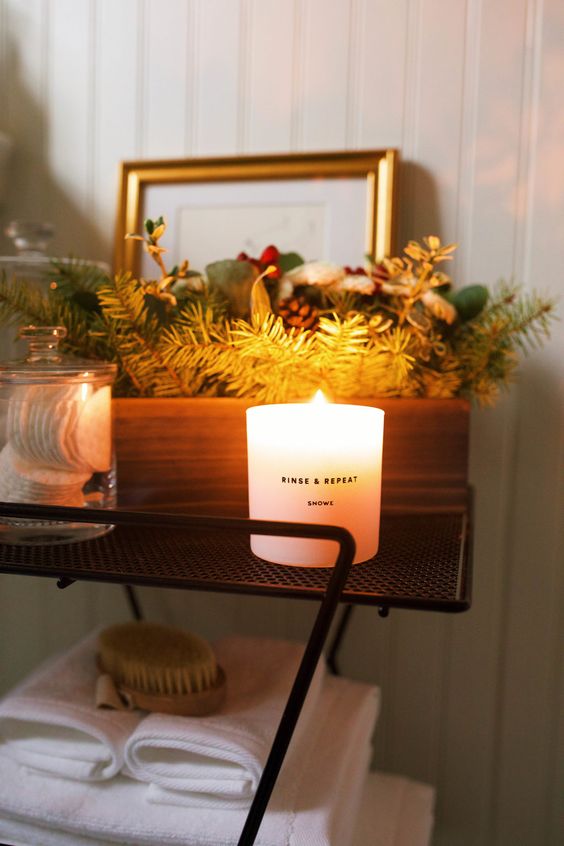 place a winter scented candle and a box with evergreens, pinecones and fake berries to achieve a holiday look