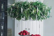 20 a lush hanging Christmas wreath chandelier with silver ornaments doesn’t take much space