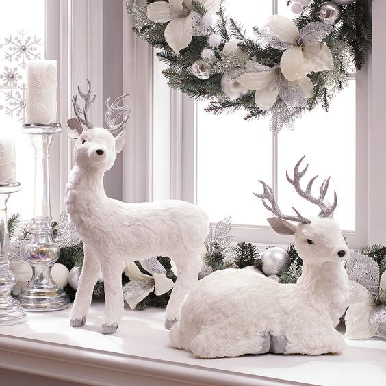 fake white deer, a beautiful fake evergreen wreath with silver and white ornaments and candles