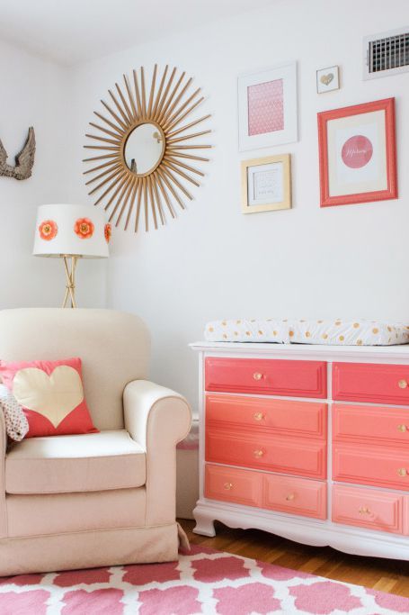 A bright ombre dresser from hot pink to light coral is a fun item for a girl's nursery