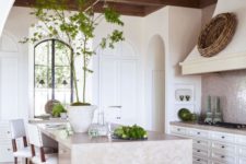 22 an inspiring kitchen with traditional cabinets, a stone kitchen island and a gorgeous wooden ceiling with beams