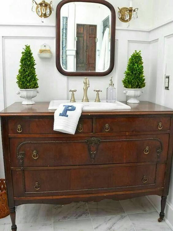 a couple of fake Christmas trees on both sides of the sink are great for a traditional bathroom