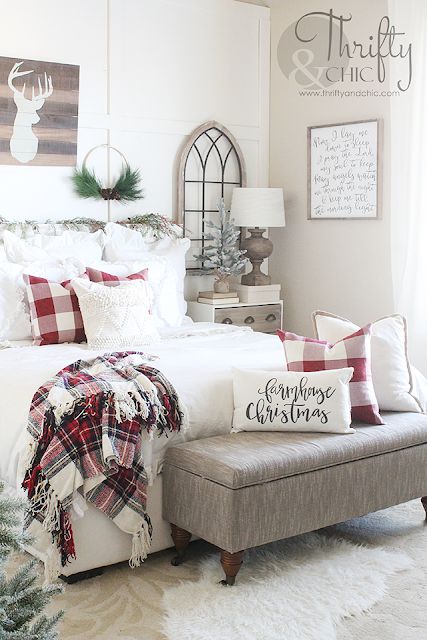 a traditional Christmas bedroom with plaids, whites and a deer artwork, some cool pillows