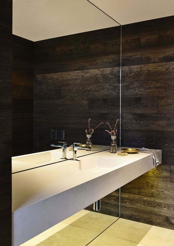 a whole mirror wall is a bold statement for a minimalist or modern bathroom, it will make the space look larger