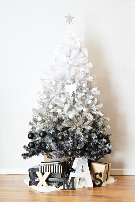 an ombre white to grey and black Christmas tree with ornaments of proper colors looks very modern and edgy