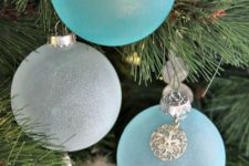25 frosted blue and white Christmas ornaments with seashell charms are amazing for a coastal feel