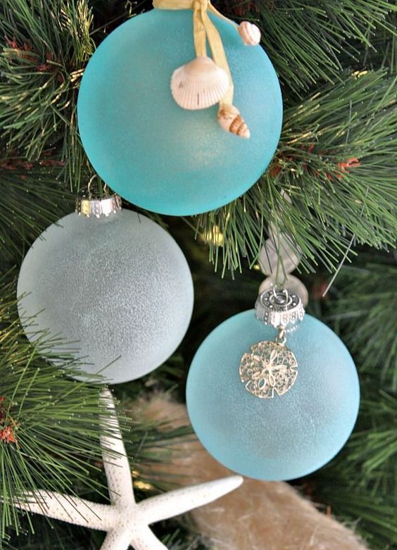 frosted blue and white Christmas ornaments with seashell charms are amazing for a coastal feel