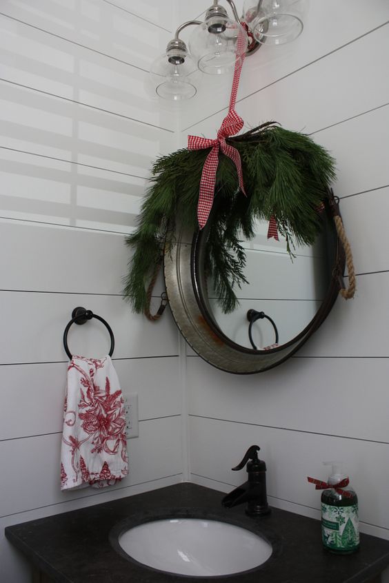 a mirror covered with evergreens, a red bow and add proper Christmas soap with winter smells