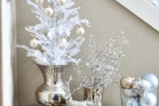 26 gold and silver ornaments can be displayed on white trees and branches, in bowls and jars for a frozen look