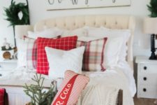 26 make your bedroom cozier with farmhouse decor, evergreen wreaths, a basket with a Christmas tree, plaid pillows and a large sign
