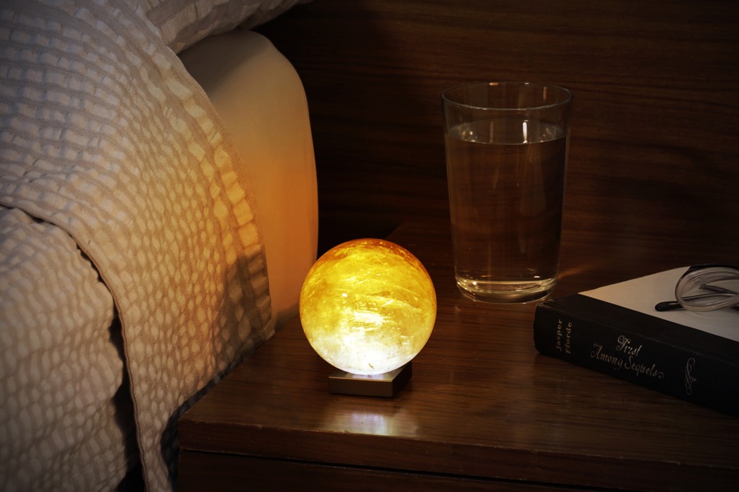 This lamp is called Solar Sun Mood lamp and is made of golden calcite, a unique crystalline structure with a translucent appearance that has a softness and warmth like no other