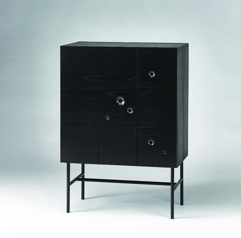 This sideboard of black wood features several wormholes and a stable black frame