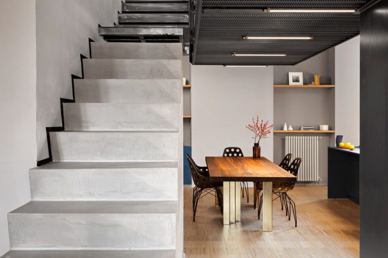 The staircase is made of concrete, too, and it connects the two levels of the apartment