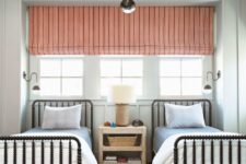 02 a chic shared guest bedroom with a tirple window covered with a coral shade and a printed rug