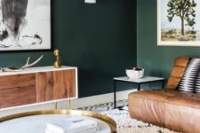 02 dark green walls contrast warm brown leather furniture and make the living room very relaxing