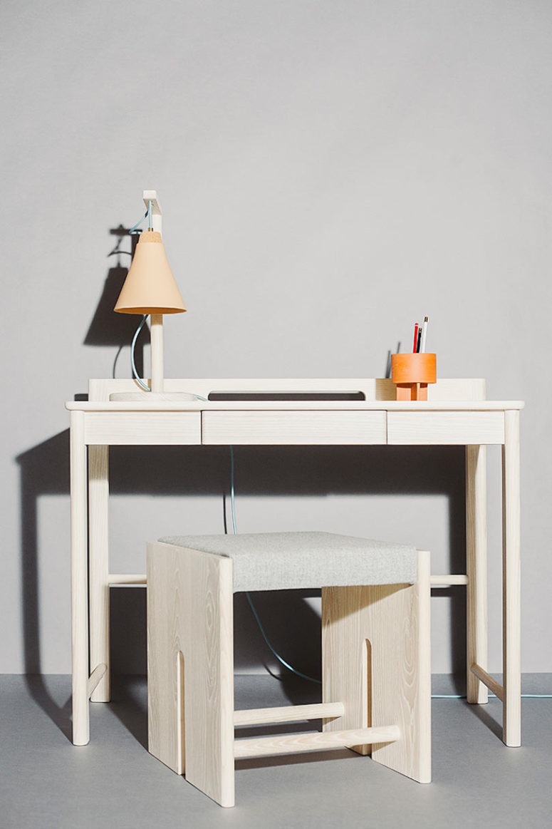 The desk and the stool are more minimalist, with the same curved angles on the desk and a hidden drawer for storage