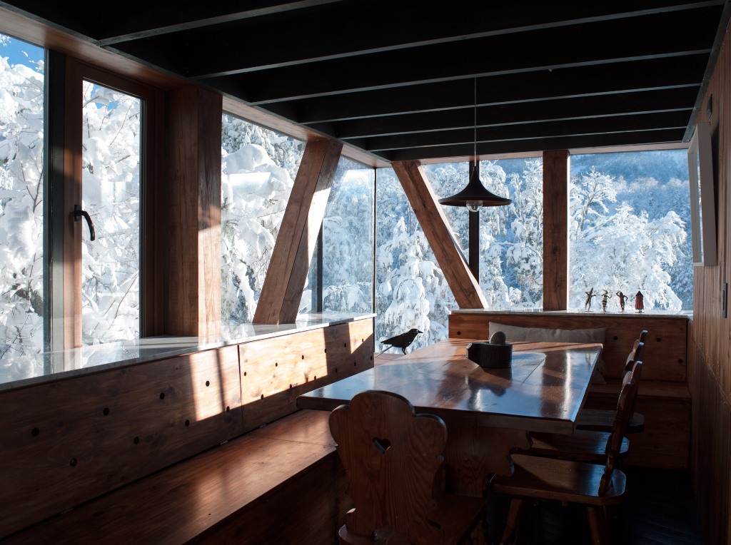 The dining space is fully of wood and there are non framed windows to catch the views while eating here