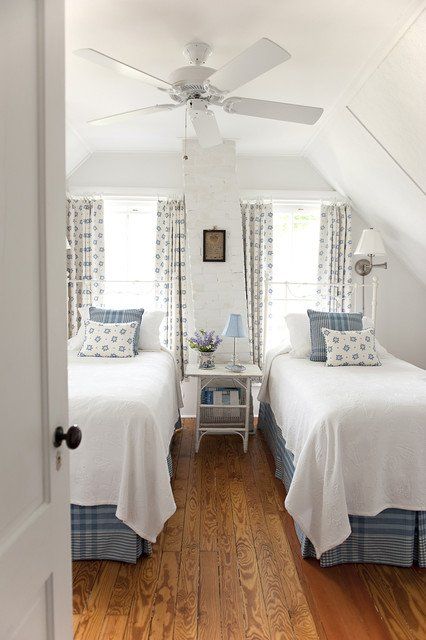 a chic vintage bedroom with two beds, two windows, much pattern and neutral for a soothing feel