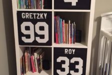 03 a cool boys’ room storage piece with black Drona boxes labeled in the sport theme