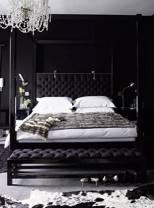 a dark glam bedroom done in black, with white bedding and touches of grey is a chic idea
