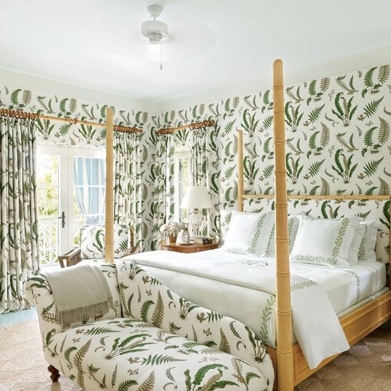 a stylish daybed at the foot of the bed features the same print as the walls and curtains in this cool feminine bedroom