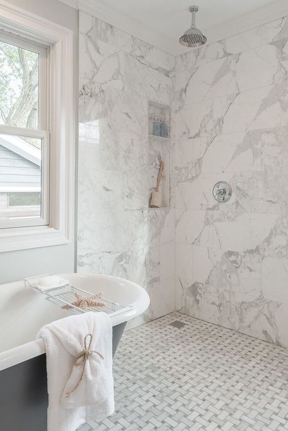 white marble tiles - graphic ones on the floor and square ones on the walls create a harmonious and cohesive space