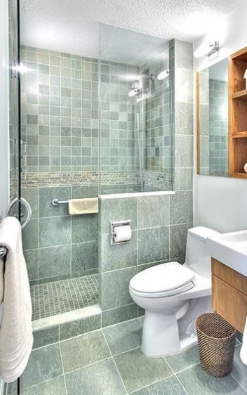 the same green color and different sizes of tiles with white grout for a relaxing and soothing little bathroom