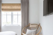 05 Roman shades and grey drapes over them add texture and interest to the space