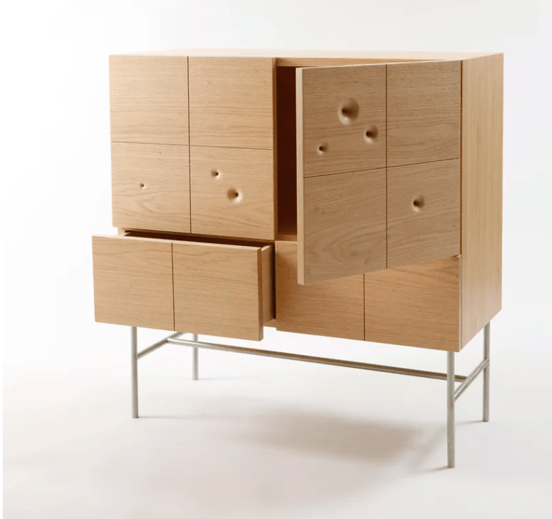The cabinet of red oak and stainless steel is a unique storage piece