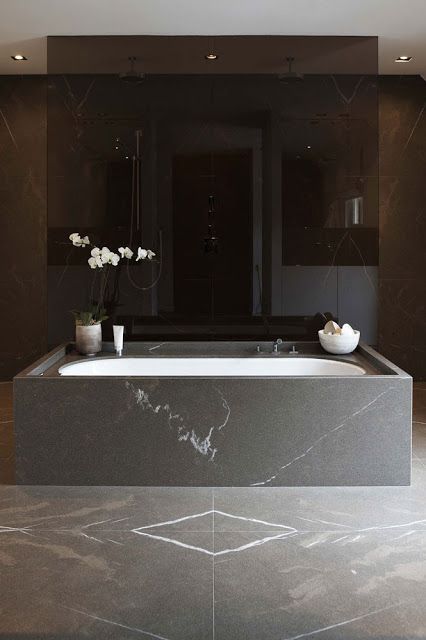 a black marble bathroom feels luxurious, and a smoked glass shower adds style and an edgy feel