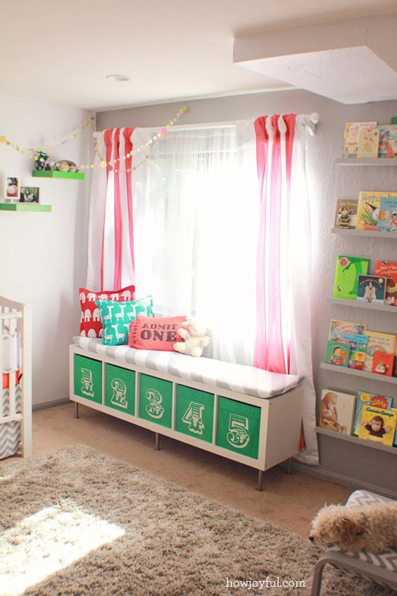 a colorful upholstered bench with numbered Drona boxes is a nice DIY for a nursery