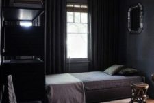 05 a comfy moody bedroom with layered rugs, thick curtains and dark bedding for winter