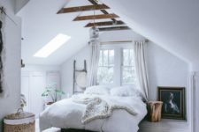 05 a modern attic bedroom with much light, dark stained beams and some built-in storage