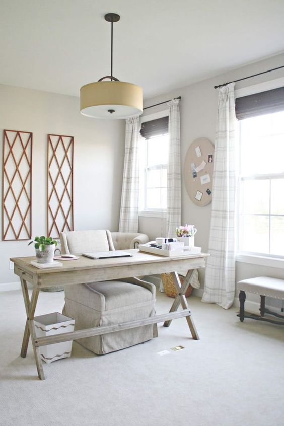 a neutral home office with whitewashed wood, various prints and lots of natural light