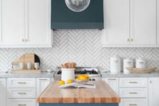 05 a white kitchen with a herringbone tile backsplash and a navy hood and kitchen island with a wooden countertop