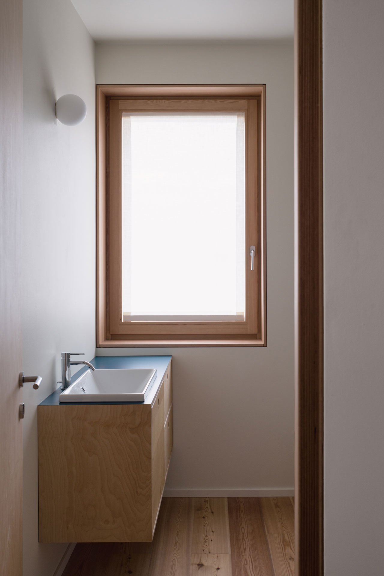 The bathrooms also feature windows that fill the space with natural light but the window is frosted
