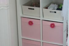 06 a comfy storage unit with open and closed storage done with pink Drona boxes with flowers