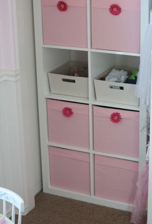 a comfy storage unit with open and closed storage done with pink Drona boxes with flowers