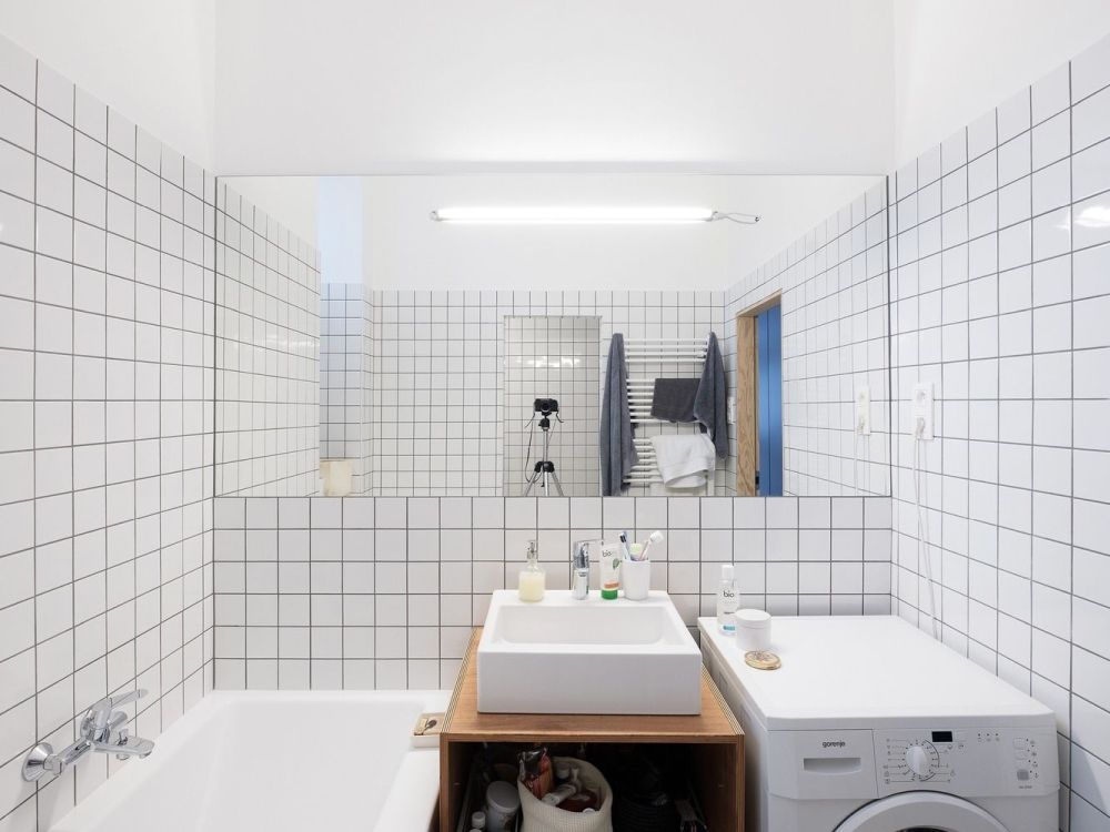 The bathroom is done with white subway tiles, black grout, there's everything necessary here
