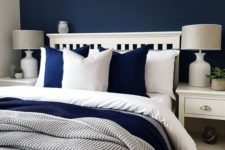 07 a cozy bedroom done in navy, white and greys looks contrasting, bold yet very inviting