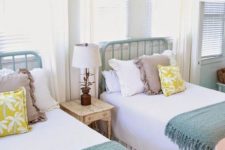 07 a cozy farmhouse twin guest bedroom with mint-painted beds and large windows