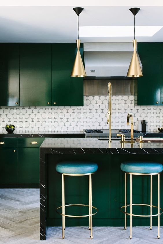 a gorgeous dark green kitchen refreshed with neutral tiles and accented with brass touches