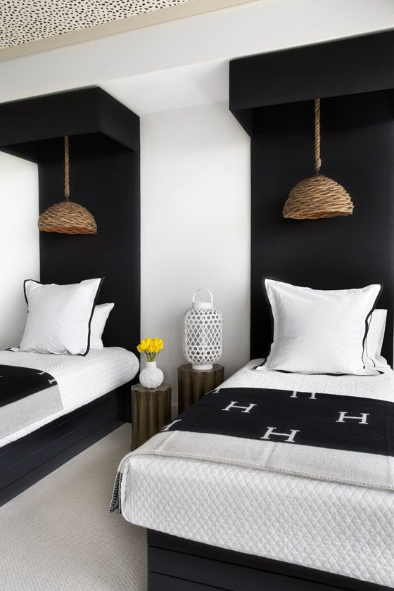 a cozy guest bedroom with a monochromatic color scheme and touches of wood and wicker