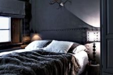 08 a welcoming dark cabin bedroom with a wooden ceiling and a faux fur throw plus wooden touches