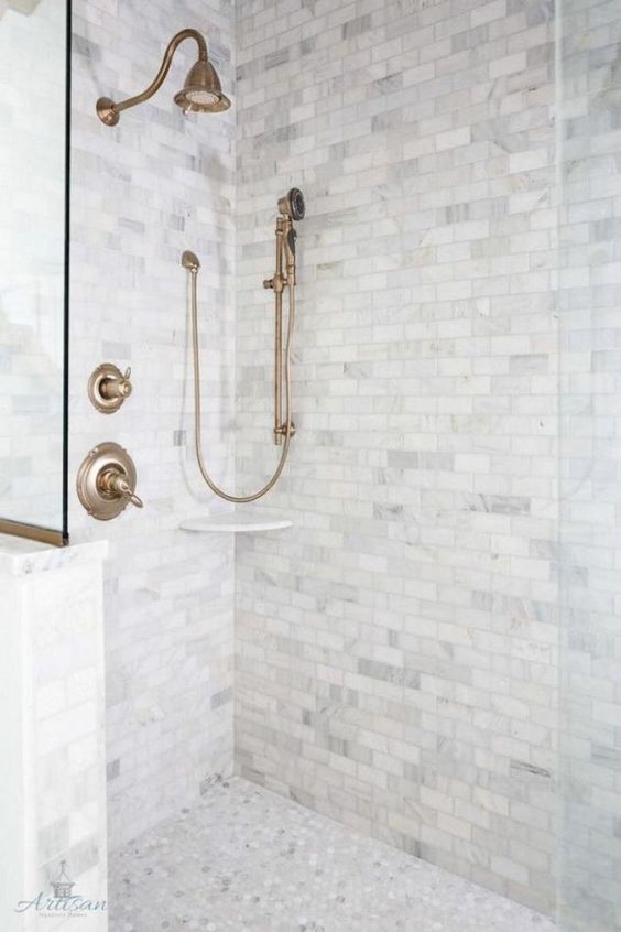 Grey marble tiles   square ones on the walls and penny hex tiles on the floor create a chic and neutral combo for a bathroom