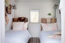 09 a cozy vintage-inspired guest bedroom with twin beds and wooden floors, walls and a ceiling