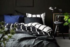 09 a moody bedroom with black walls, vintage finds and touches of fresh greenery for freshness