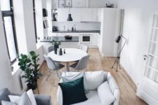 09 a tiny home with a dining, living space and a kitchen, all of them are united into a flowing space to fill it with light