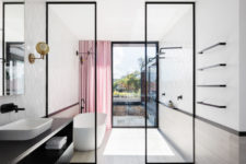 10 The bathroom is light-filled, airy and spacious accented with black touches and a pink curtain