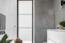 11 Another bathroom features concrete iles and a frosted glass window